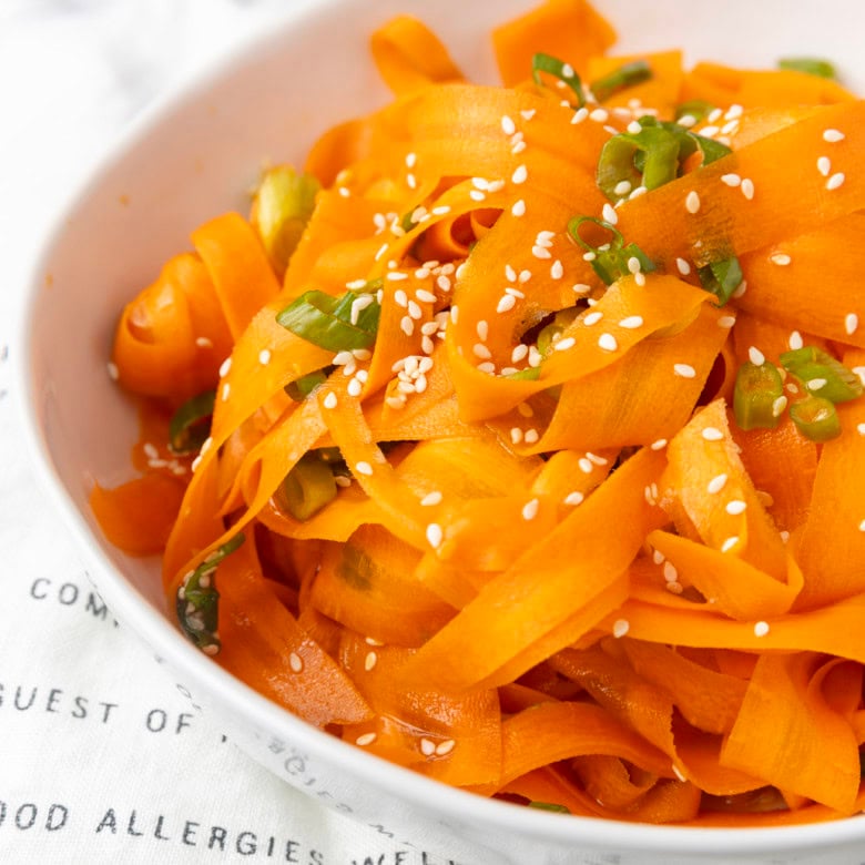 carrot ribbon salad in a white bowl