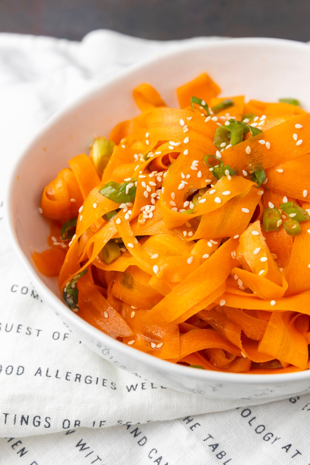 carrot ribbon salad in a white bowl