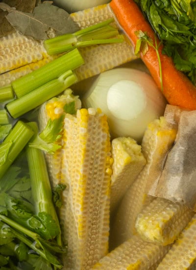 corn cobs and vegetables in a stockpot to make corn stock