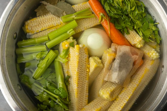 corn cobs and vegetables in a stockpot to make corn stock