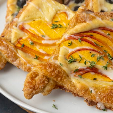 peach cream cheese puff pastry with thyme on plate