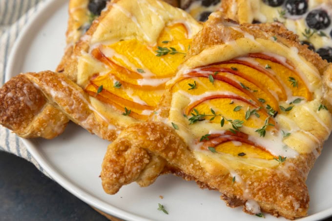peach cream cheese puff pastry with thyme on plate