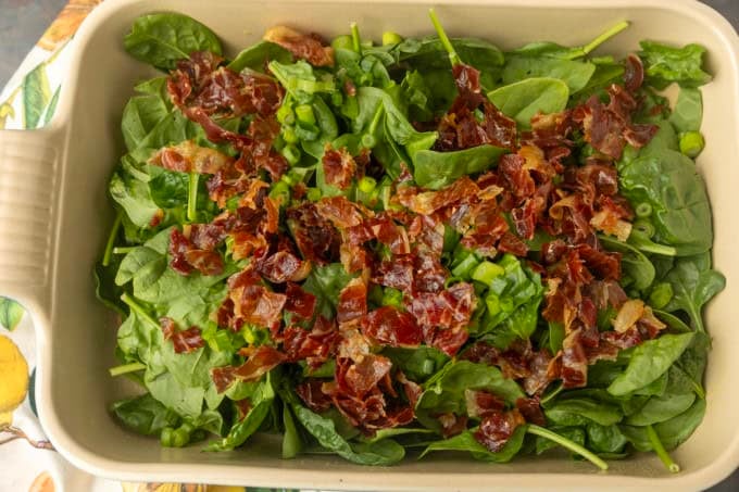 spinach and crispy prosciutto in a pan for high protein egg bake