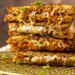 stack of kimchi grilled cheese on a cooling rack.