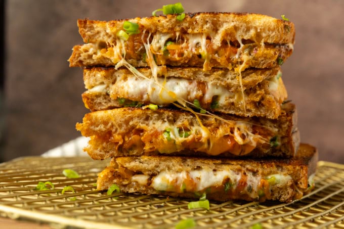 stack of kimchi grilled cheese on a cooling rack.