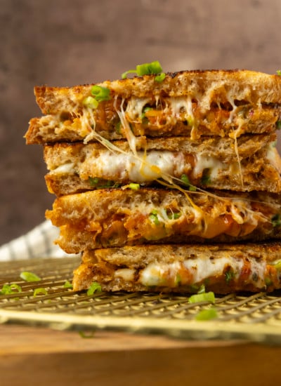 stack of kimchi grilled cheese on a cooling rack.