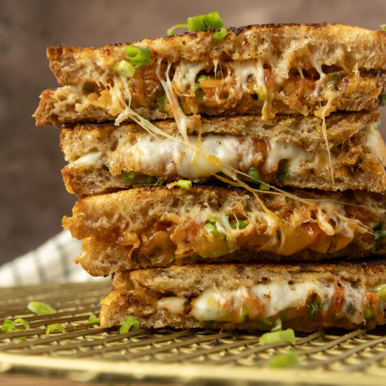stack of kimchi grilled cheese on a cooling rack.