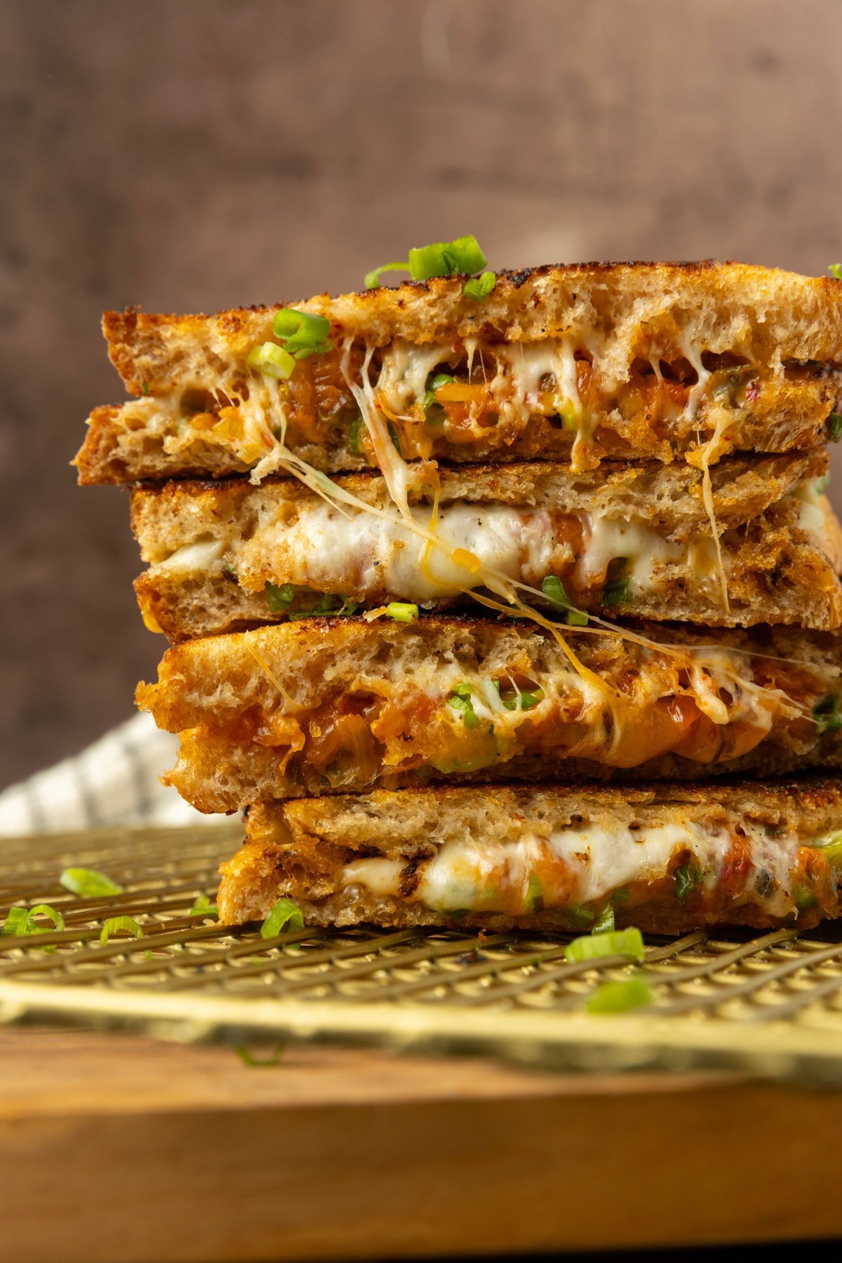 stack of kimchi grilled cheese on a cooling rack.