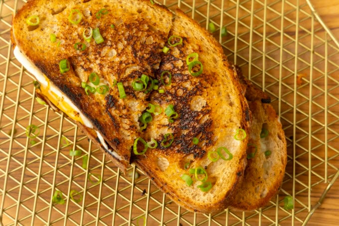 stack of kimchi grilled cheese on a cooling rack.