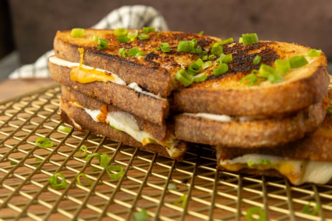 stack of kimchi grilled cheese on a cooling rack.
