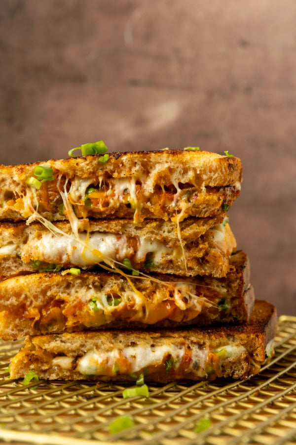 stack of kimchi grilled cheese on a cooling rack.