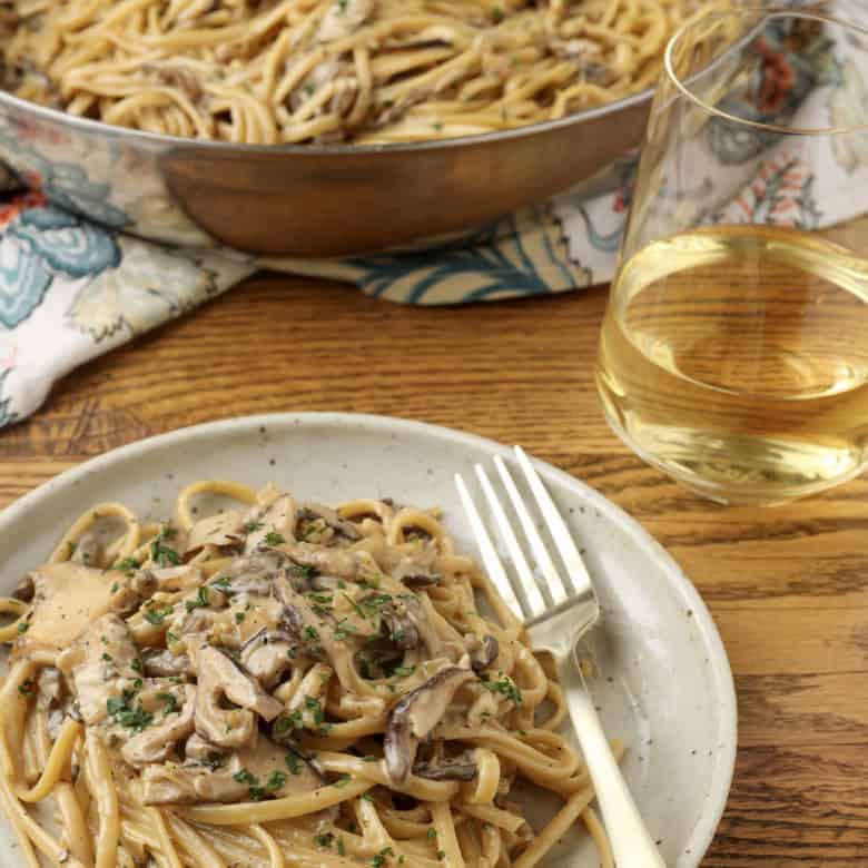 miso mushroom pasta on a plate and in a pan