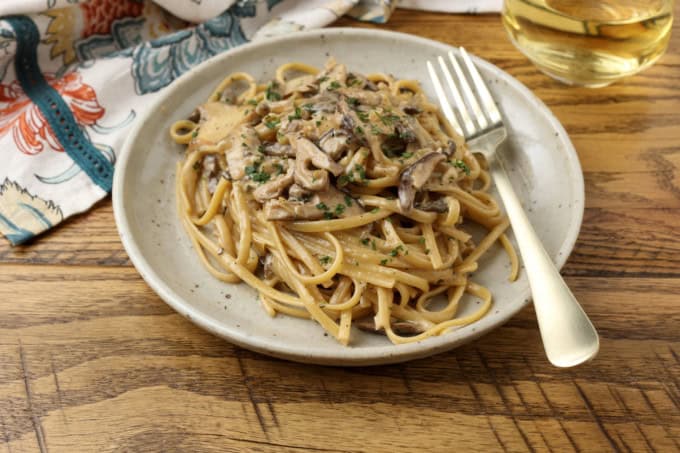miso mushroom pasta on. plate with a fork