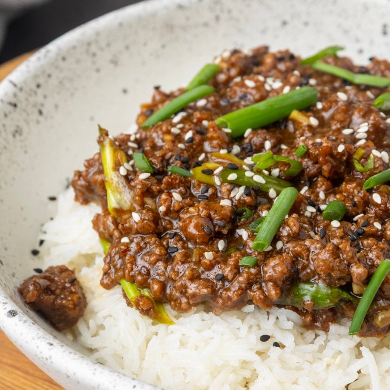 mongolian ground beef on rice in a bowl