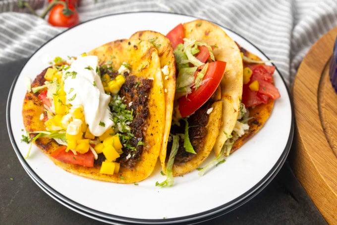 smashed tacos on stacked plates