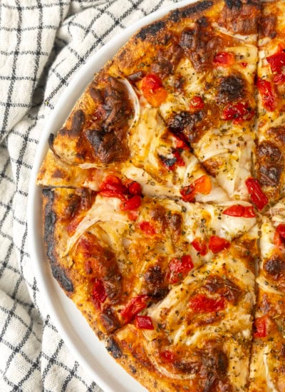 tuna pizza with corn, olives, onions, and roasted red peppers