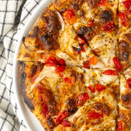 tuna pizza with corn, olives, onions, and roasted red peppers