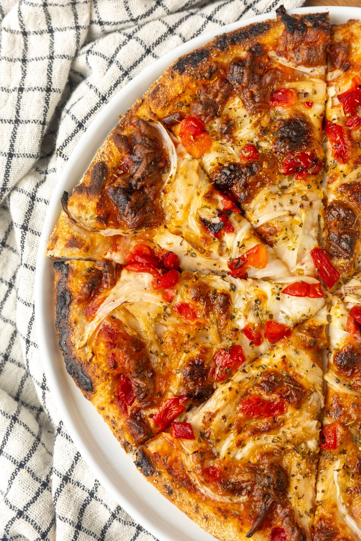 tuna pizza with corn, olives, onions, and roasted red peppers