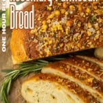 partially sliced one hour rosemary parmesan bread on parchment paper with text describing the photo over it