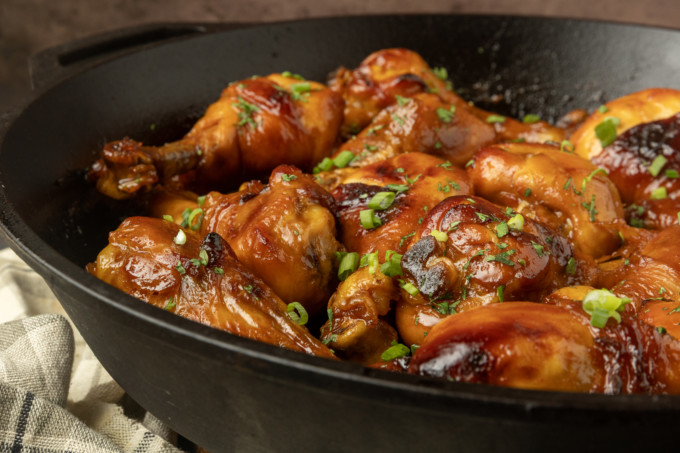 baked honey garlic chicken in a cast-iron pan