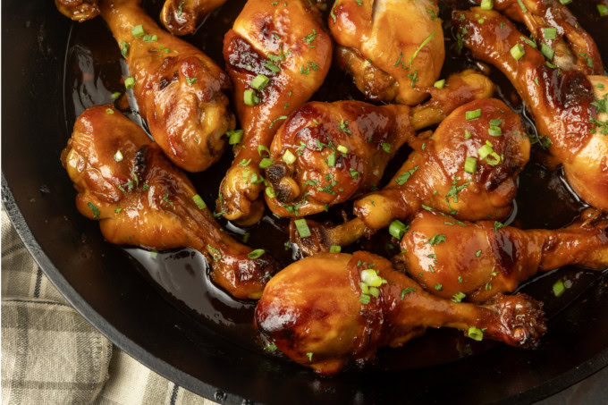 baked honey garlic chicken in a cast-iron pan