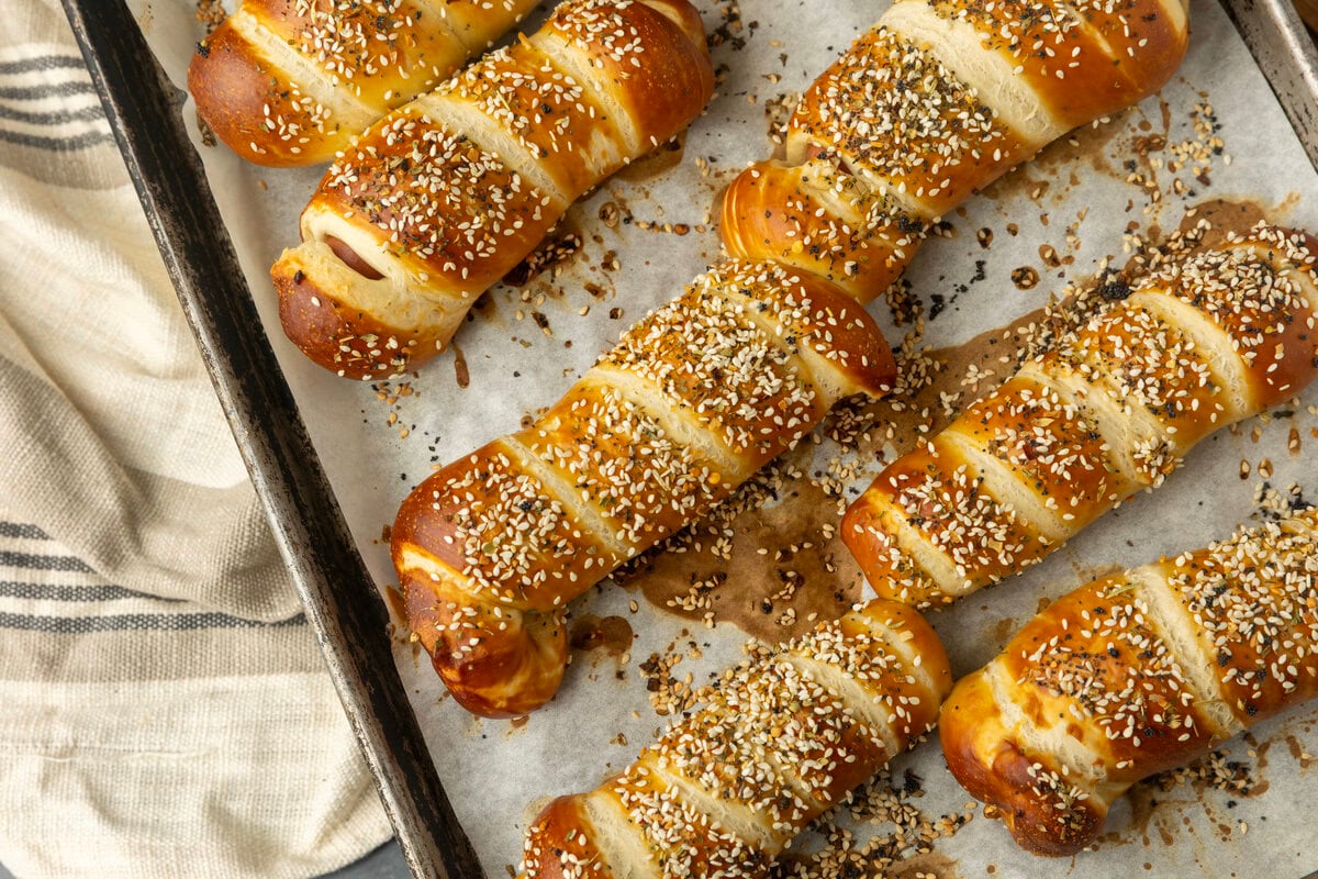 pretzel dogs on parchment paper on a pan