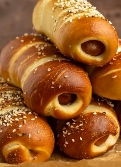 pretzel dogs on parchment paper on a pan with a variety of dipsa