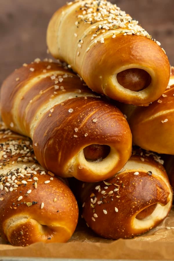 pretzel dogs on parchment paper on a pan with a variety of dipsa