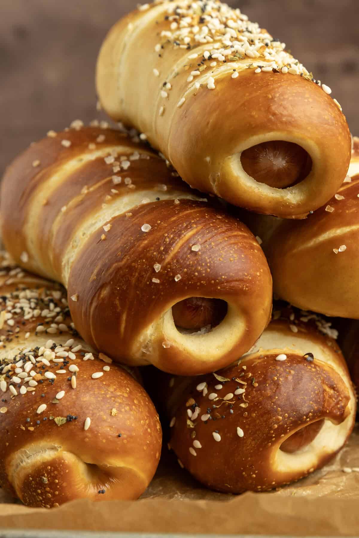 pretzel dogs on parchment paper on a pan with a variety of dipsa