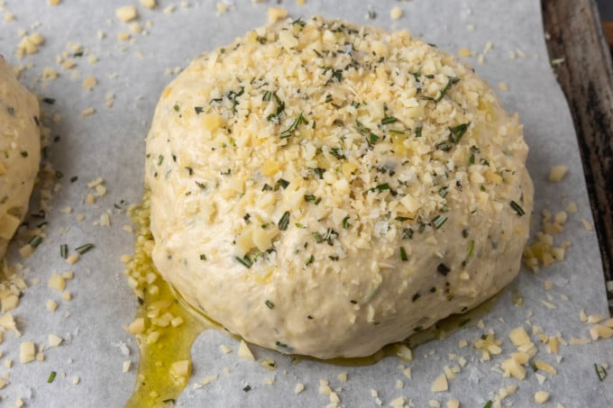 Unbaked Rosemary Parmesan Garlic Bread on a parchment lined sheet pan