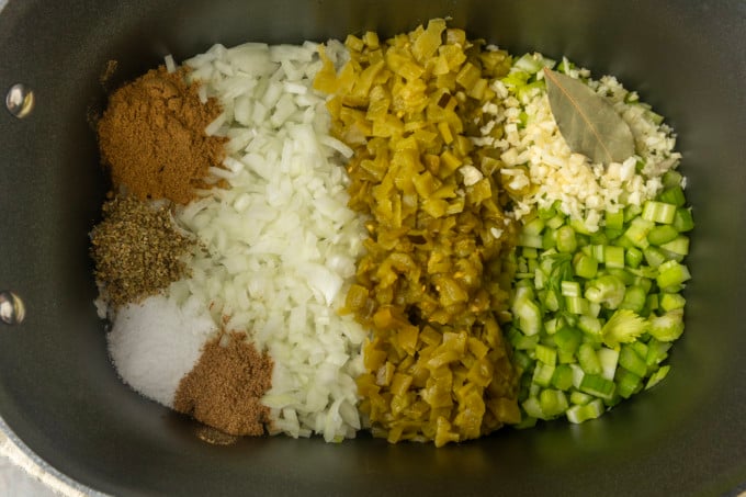 chicken breast, celery, onion, garlic, diced chiles, spices, and bay leaf in a slow cooker for white bean chicken chili