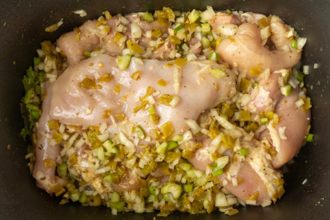 chicken breast, celery, onion, garlic, diced chiles, spices, and bay leaf in a slow cooker for white bean chicken chili