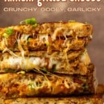 stack of kimchi grilled cheese with a lot of melted cheese pulling out of it and text overlay describing the photo