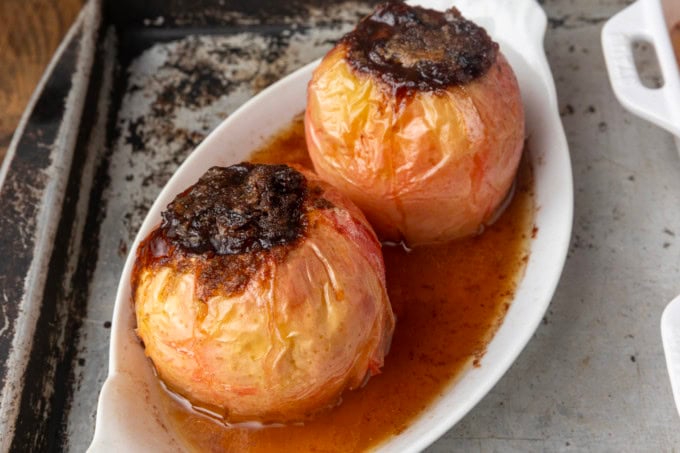 baked apples stuffed with brown sugar, butter, and dried cranberries in ramekins