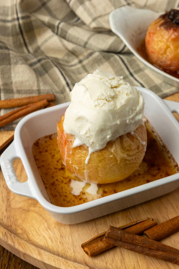 apples stuffed with brown sugar, butter, and dried cranberries in ramekins