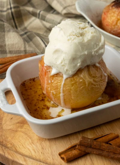 apples stuffed with brown sugar, butter, and dried cranberries in ramekins, baked, topped with vanilla ice cream