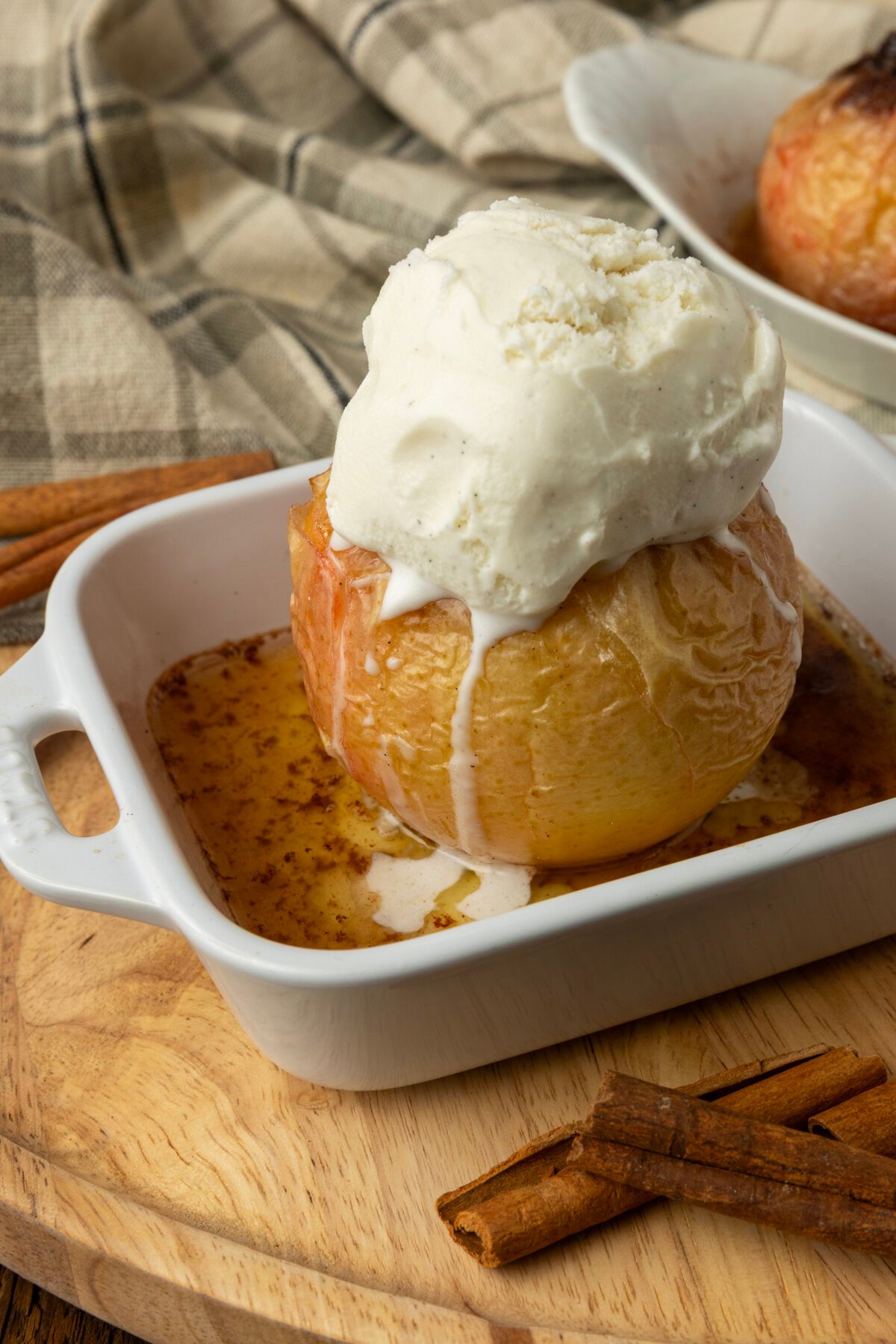 apples stuffed with brown sugar, butter, and dried cranberries in ramekins, baked, topped with vanilla ice cream