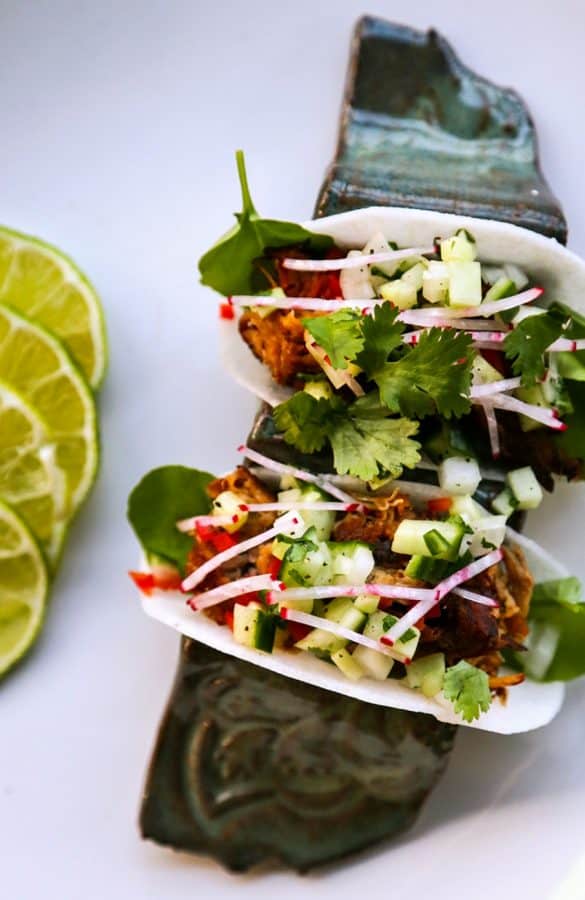 Jicama Tacos with carnitas, cucumber onion salsa, radishes, and cilantro.