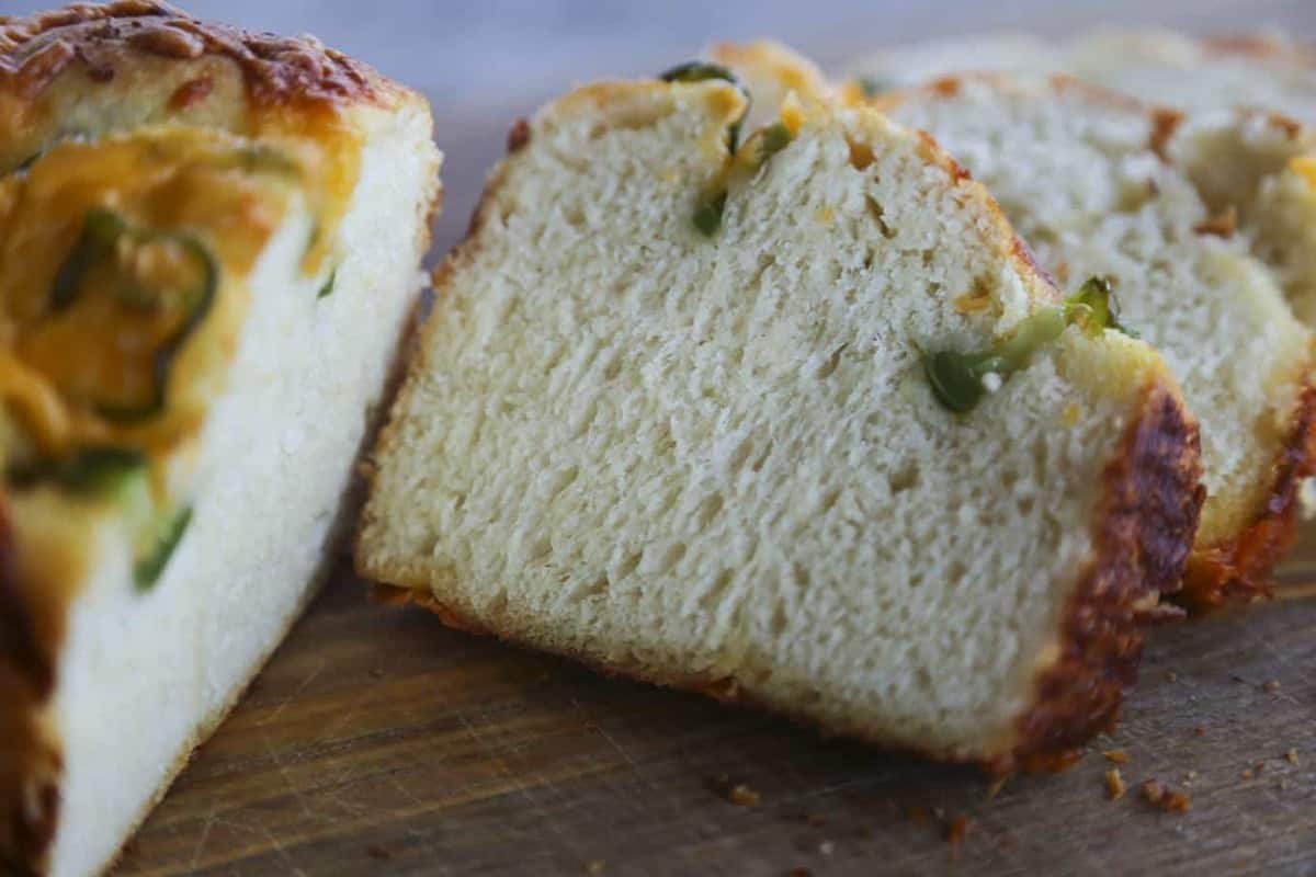 Jalapeno Cheddar Bread: tender sandwich bread studded with fresh jalapeno slices and lovely melted cheddar cheese with a thick cap of toasted cheddar on top. Just like Wegman's bakery bread!