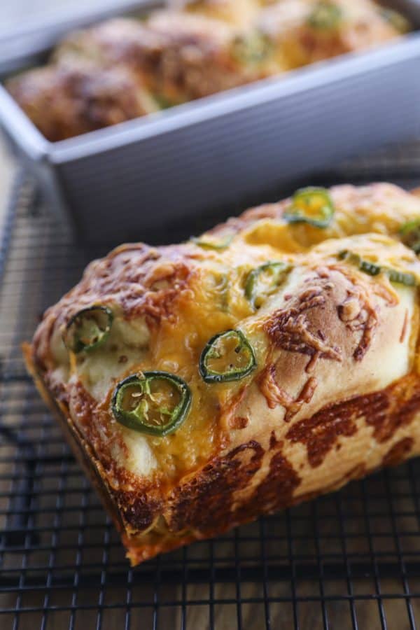 Jalapeno Cheddar Bread: tender sandwich bread studded with fresh jalapeno slices and lovely melted cheddar cheese with a thick cap of toasted cheddar on top. Just like Wegman's bakery bread!