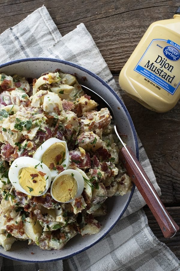 This next level potato salad has a full pound of crispy bacon, a creamy dressing with a hint of Dijon mustard, fresh herbs, hard boiled eggs, and tender potatoes. It's sure to be your new favourite potato salad for grilling and picnic season.