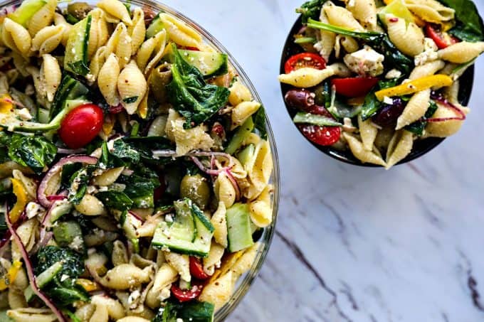 Vegetable lovers rejoice! This Veggie Lover's Greek Pasta Salad is absolutely bursting with baby spinach, cucumbers, tomatoes, bell peppers, Greek olives, and red onions all in a tantalizing garlicky herbed lemon dressing.