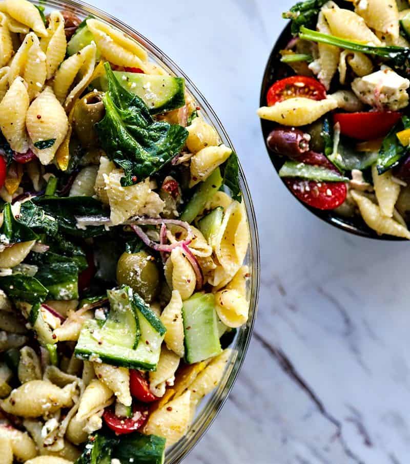 Vegetable lovers rejoice! This Veggie Lover's Greek Pasta Salad is absolutely bursting with baby spinach, cucumbers, tomatoes, bell peppers, Greek olives, and red onions all in a tantalizing garlicky herbed lemon dressing.