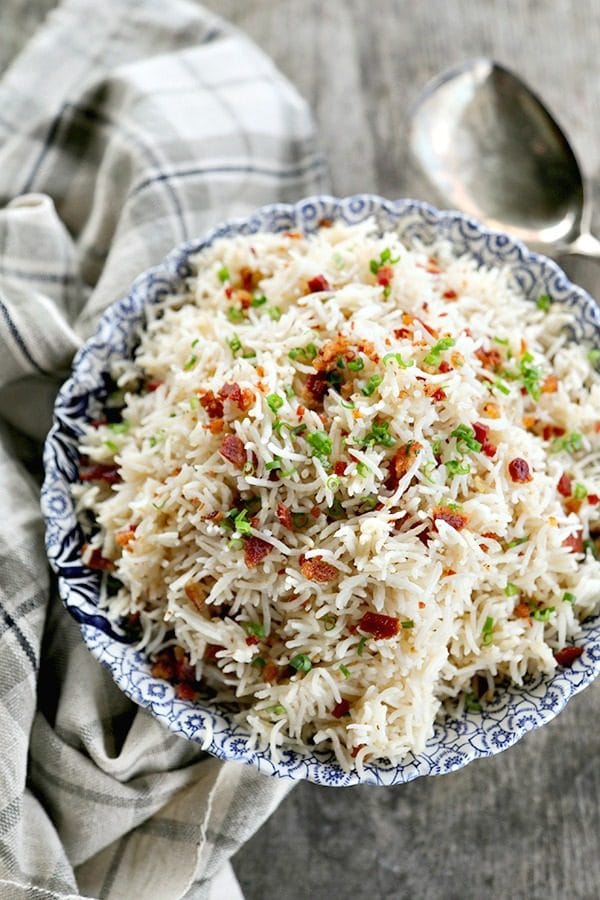 Bacon Garlic Rice; tender grains of basmati rice bursting with bacon, fried garlic, and fresh green onion. It's a flavour explosion that is great with grilled chicken, fish, beef, or pork, or nibbled straight from the fridge at midnight.