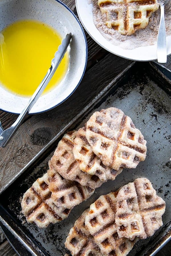 Crispy edged, cinnamon-sugar dusted Churros Waffles are 100% irresistible and ridiculously easy to make, taking advantage of frozen dough for the base. Bonus: No boiling oil!