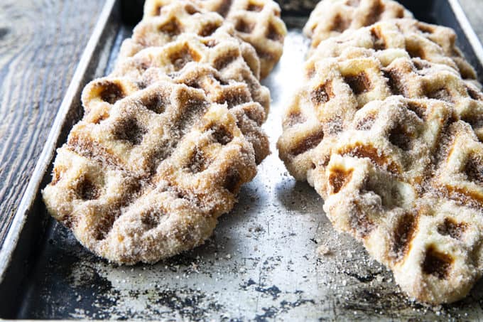 Crispy edged, cinnamon-sugar dusted Churros Waffles are 100% irresistible and ridiculously easy to make, taking advantage of frozen dough for the base. Bonus: No boiling oil!