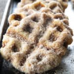 Crispy edged, cinnamon-sugar dusted Churros Waffles are 100% irresistible and ridiculously easy to make, taking advantage of frozen dough for the base. Bonus: No boiling oil!