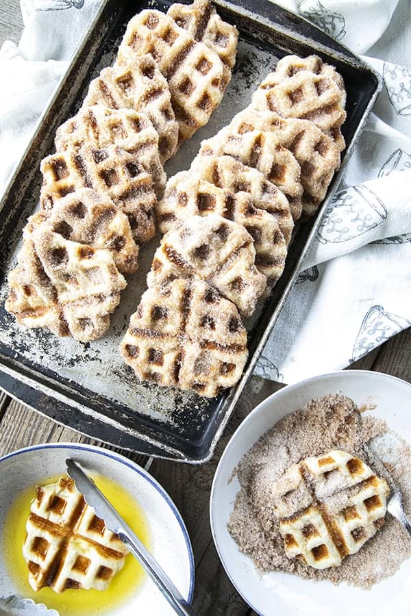 Crispy edged, cinnamon-sugar dusted Churros Waffles are 100% irresistible and ridiculously easy to make, taking advantage of frozen dough for the base. Bonus: No boiling oil!