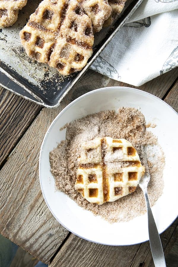 Crispy edged, cinnamon-sugar dusted Churros Waffles are 100% irresistible and ridiculously easy to make, taking advantage of frozen dough for the base. Bonus: No boiling oil!