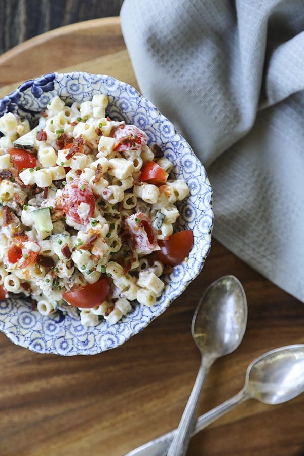 Tender, little ditalini, crunchy yellow and orange bell pepper, cucumber, crispy bacon crumbles, tiny cubes of Cheddar and pepper jack cheese, and minced fresh jalapeño pepper and chives in a creamy ranch dressing make this Spicy Bacon Cheddar Pasta Salad recipe scream summer!
